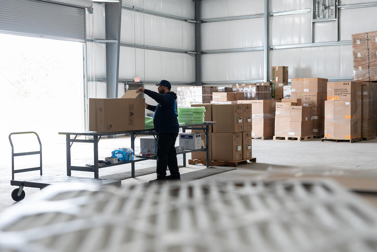 Man packs a box at the distribution center in Sumter, SC